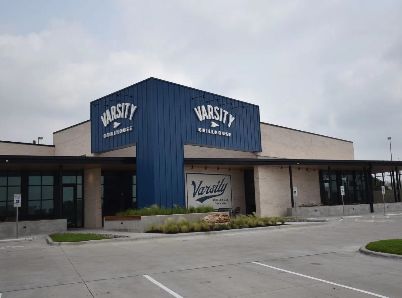 Completed Varsity Grillhouse exterior with a tall entry feature and covered patio