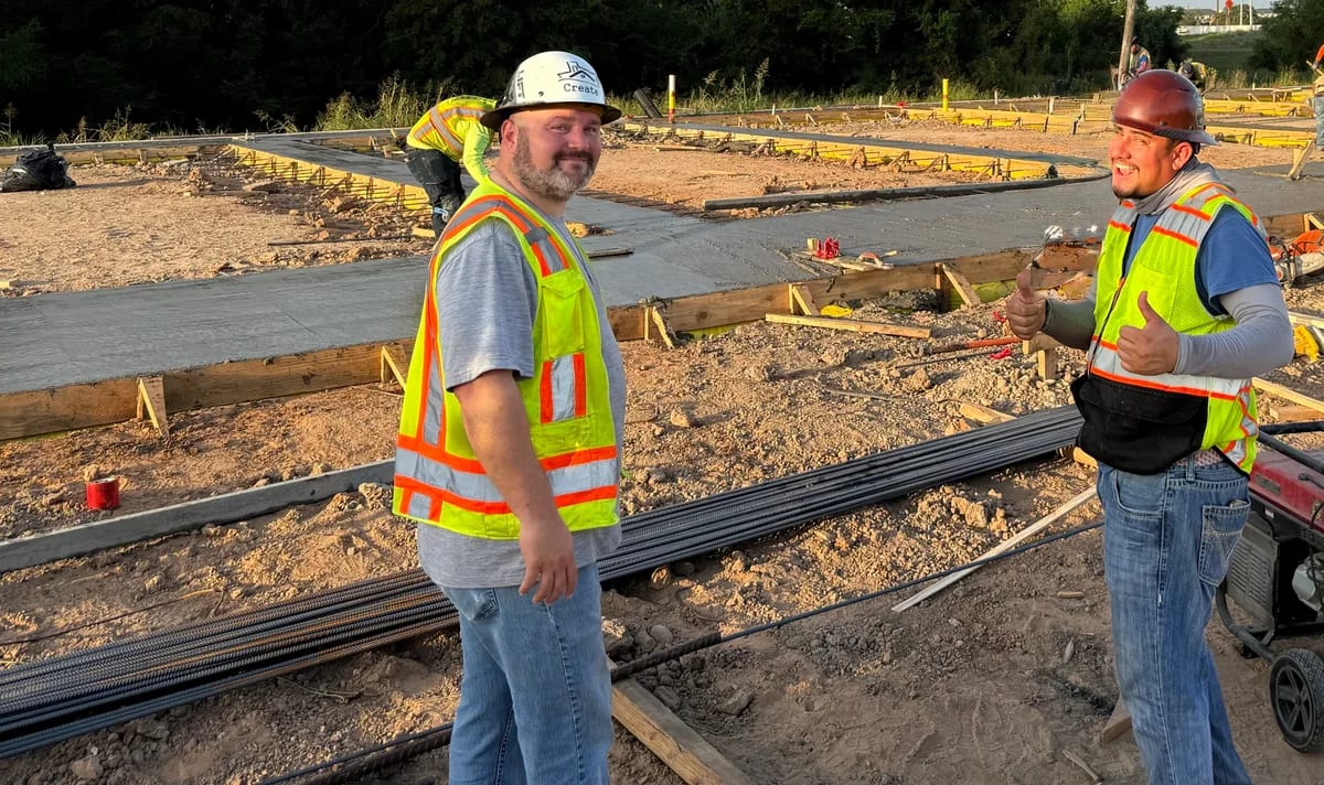 Two members of the team beside a concrete placement
