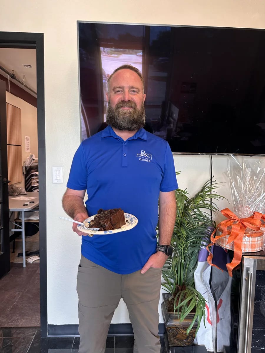 A team member holding a plate at a shared meal