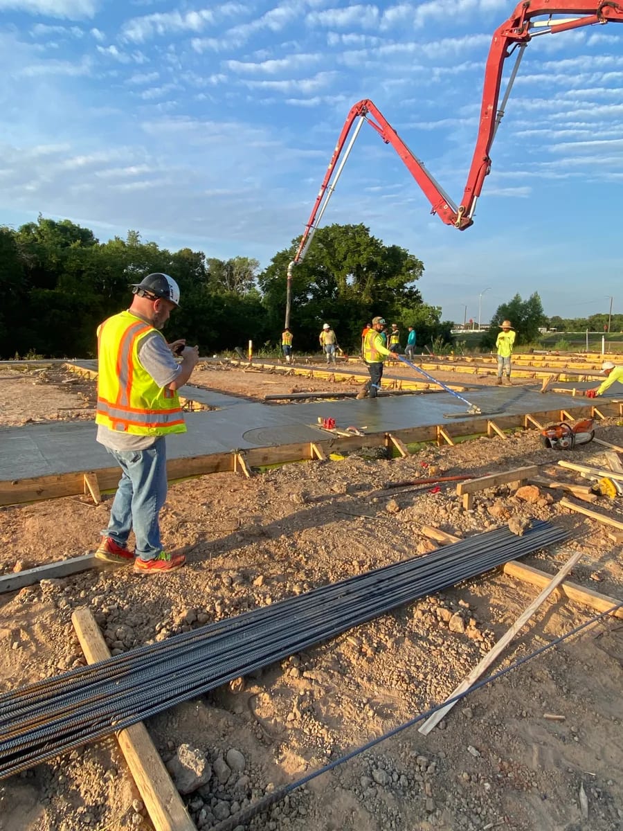 A team member beside a concrete placement
