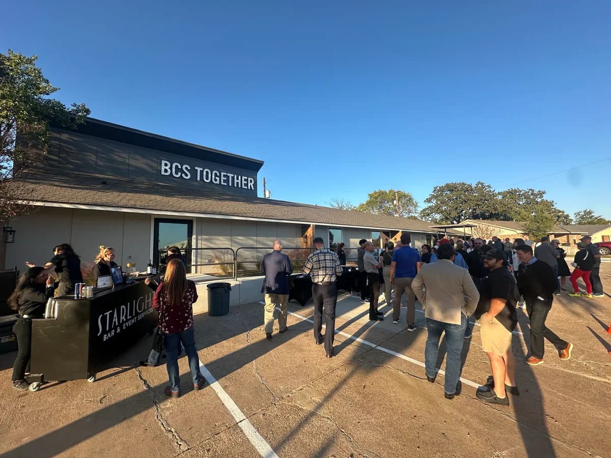 People arriving at an outdoor community gathering