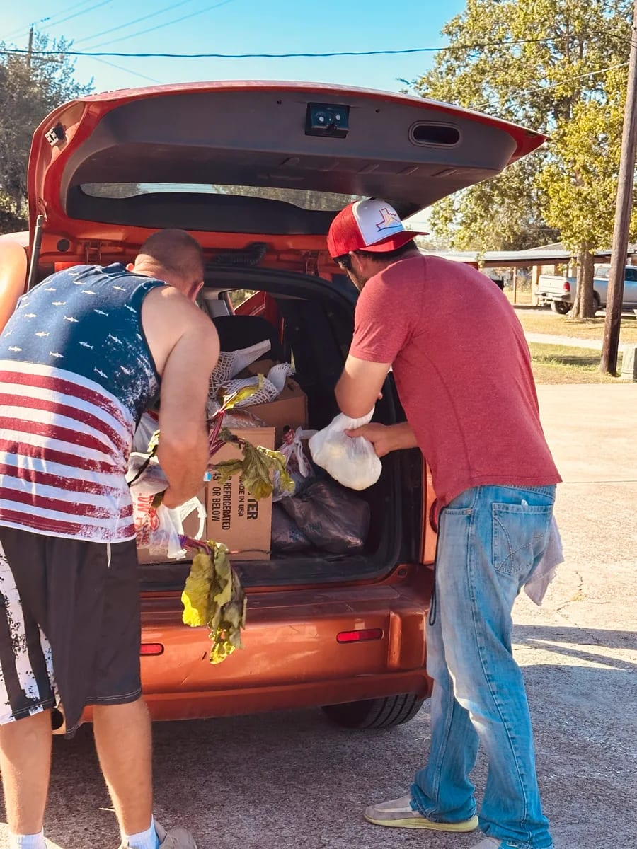 Volunteers unloading supplies from a car